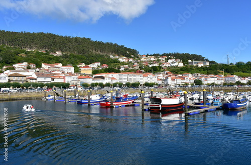 Harbor and coastal village with galician fishing boats and sailing boats at famous Rias Baixas in Galicia Region. Muros, A Coruña, Spain.