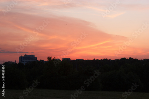 Beautiful bright sunset with cloudscape and multicolored evening glowing over skyline