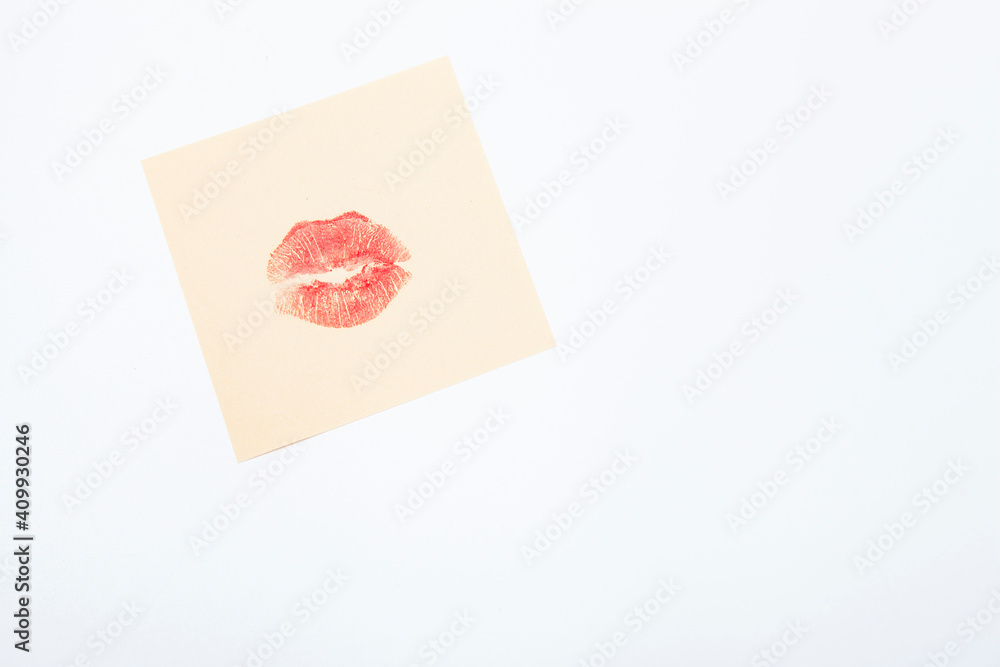 Red lipstick kiss on yellow memo paper piece Red lipstick kiss on yellow memo paper piece