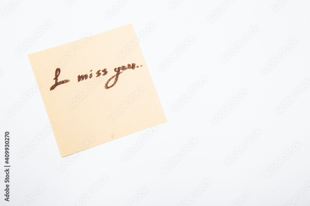 I miss you handwritten on yellow memo paper I miss you handwritten on yellow memo paper