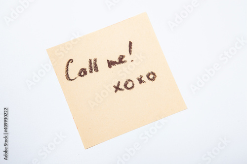 Yellow sticky note with handwritten call me memo
