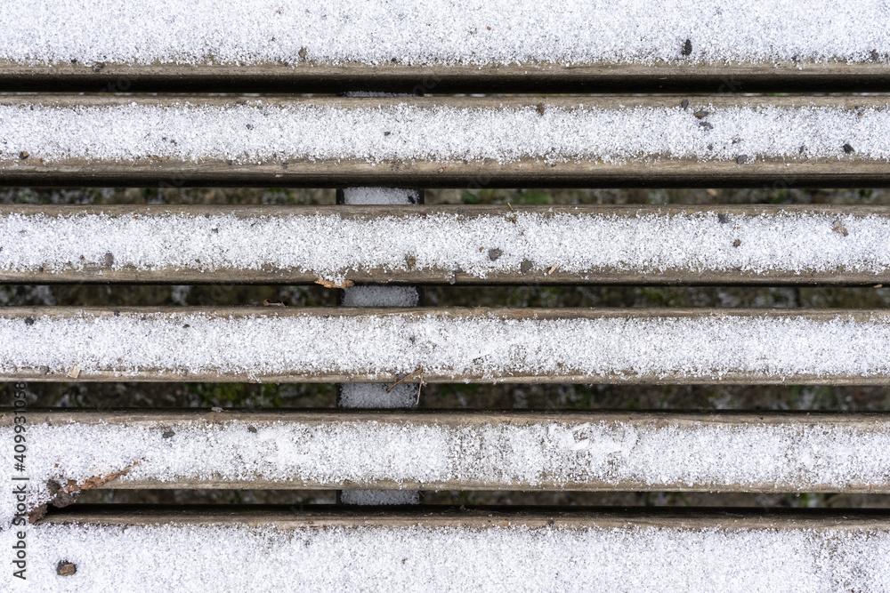 Snow-dusted wooden grating. Background.