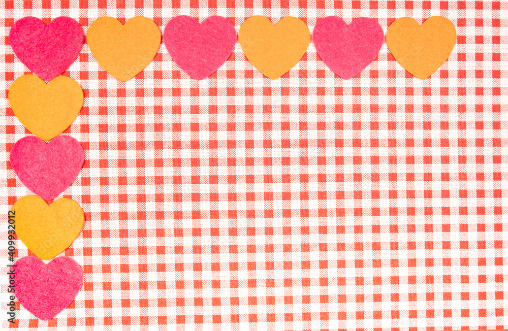 background with red and white Vichy fabric for Valentine's Day with pink and orange hearts. valentines day concept background with red and white Vichy fabric for Valentine's Day with pink and orange hearts. valentines day concept
