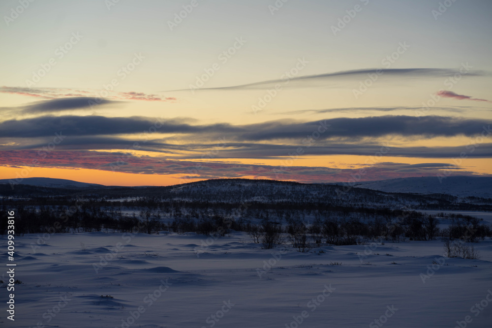 bright dawn in winter with large clouds