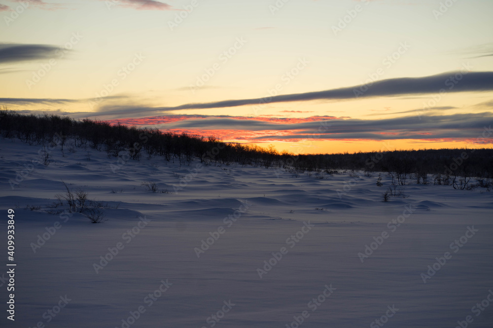 bright dawn in winter with large clouds