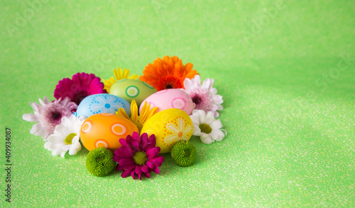 spring background with colorful flowers and decorated eggs