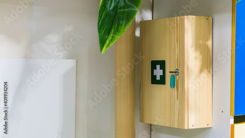 Wood first aid kit box on on a white wall in interiors
