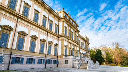Facade of the elegant Villa Reale in Monza, Italy. Blue sky and white clouds in the background. Villa Reale translation: Royal Villa
