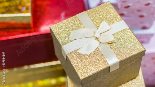 gold Gift box  with white ribbon close up