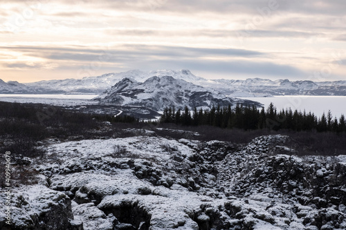 View over the fault line between the North American and Eurasian continental plates on Lake   ingvallavatn with the small peninsula of Mj  anes and the island of Sandey in   ingvellir National Park . 