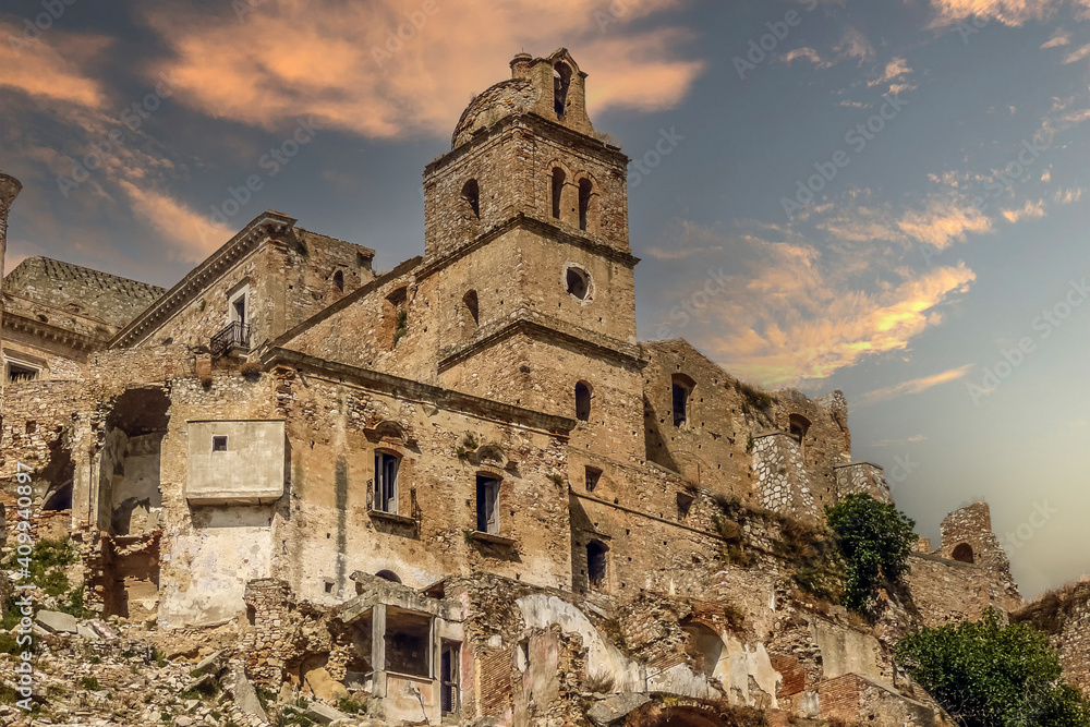 Abandoned ruined houses in the ghost town of Craco at sunset