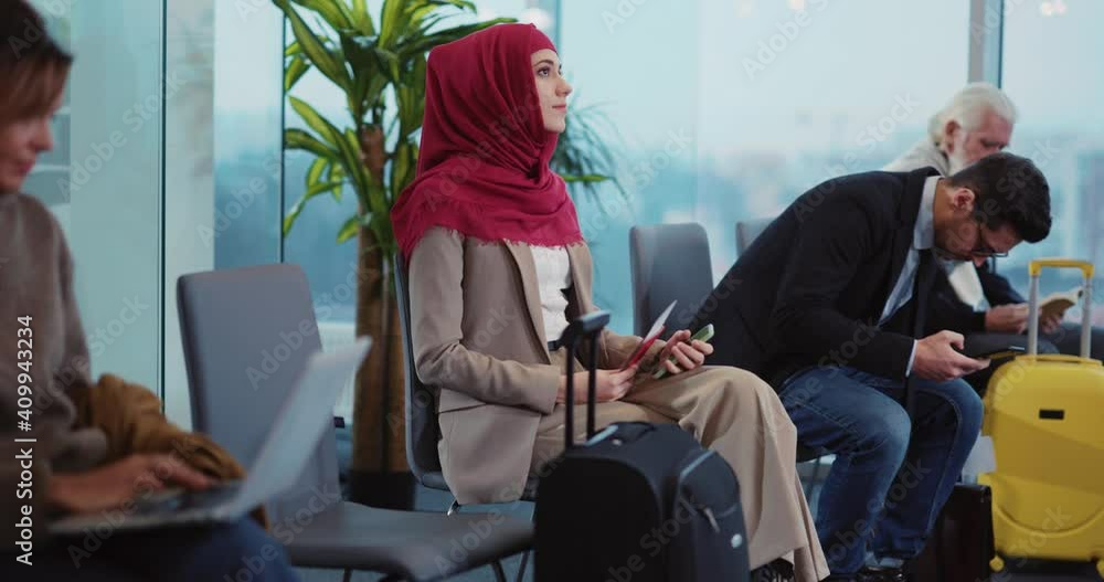 Multi-national diverse business people sitting in the public waiting room at airport terminal. Waiting for flight. Departure lounge. Concept for travel. Multi-national diverse business people sitting in the public waiting room at airport terminal. Waiting for flight. Departure lounge. Concept for travel.
