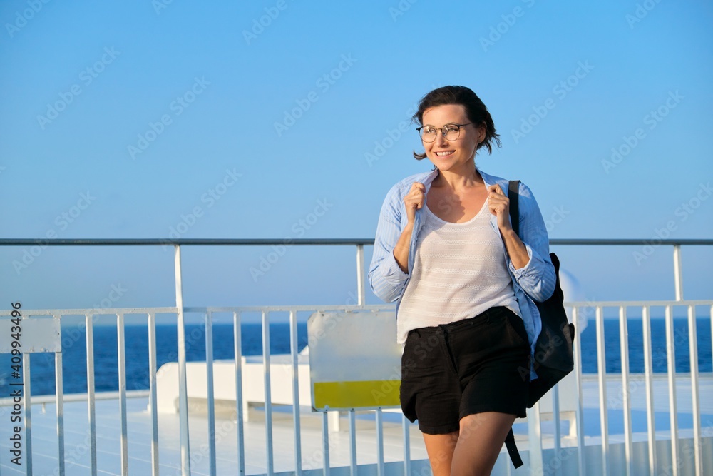 Beautiful happy mature woman on deck of ship, ferry, enjoying sea voyage Beautiful happy mature woman on deck of ship, ferry, enjoying sea voyage