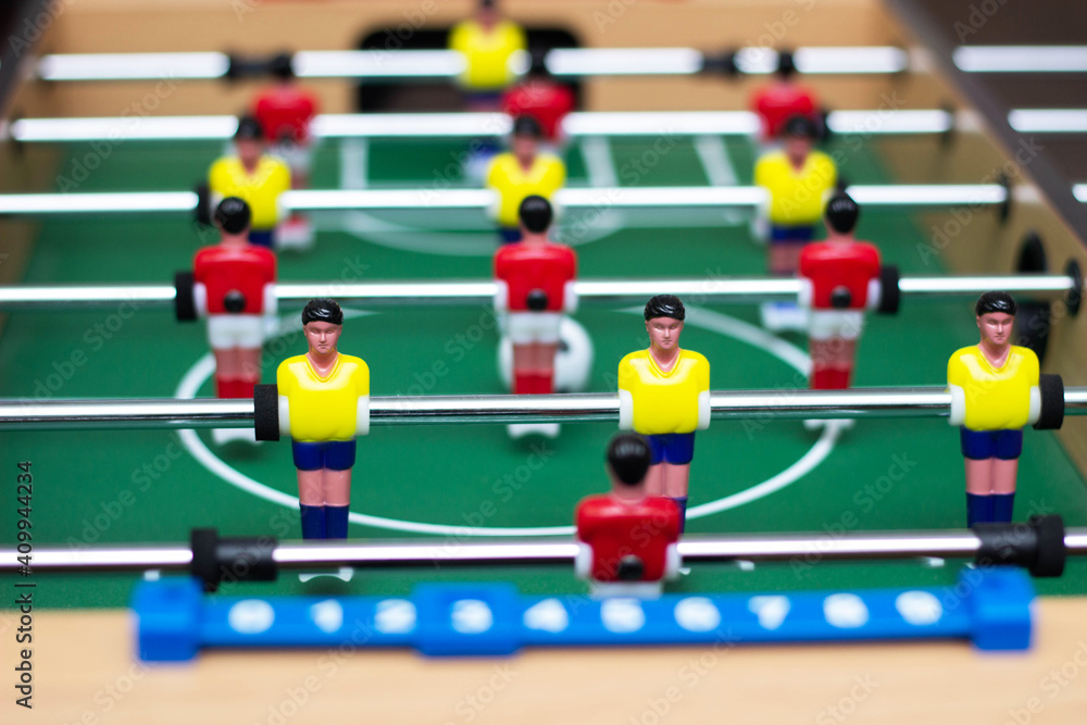 Fototapeta premium Details of a table soccer game. Table football is a toy for children. Close up. Selective focus