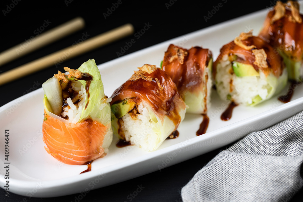 Closeup of palatable rolls filled with fresh turnip and garnished with teriyaki sauce Closeup of palatable rolls filled with fresh turnip and garnished with teriyaki sauce