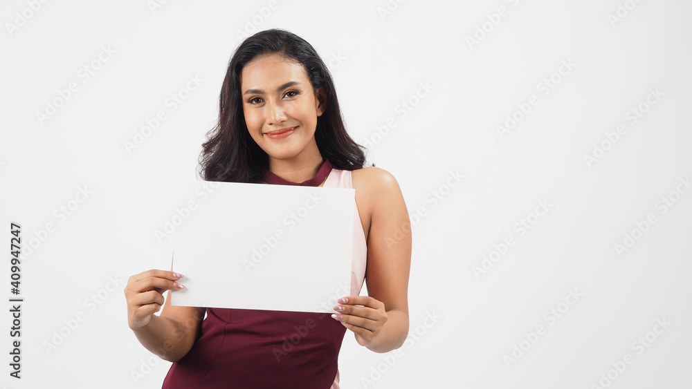 Asian beautiful young woman holding empty blank paper. A studio portrait with white background .Empty Space for text .She have tan skin. Asian beautiful young woman holding empty blank paper. A studio portrait with white background .Empty Space for text .She have tan skin.