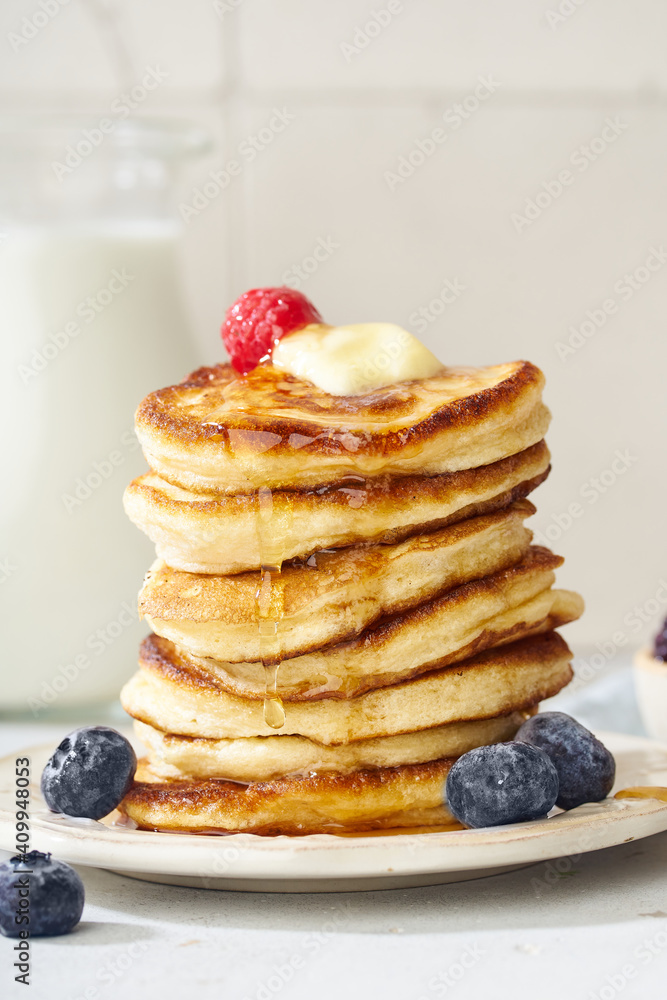 Fluffy breakfast pancakes with maple syrup and berries Fluffy breakfast pancakes with maple syrup and berries