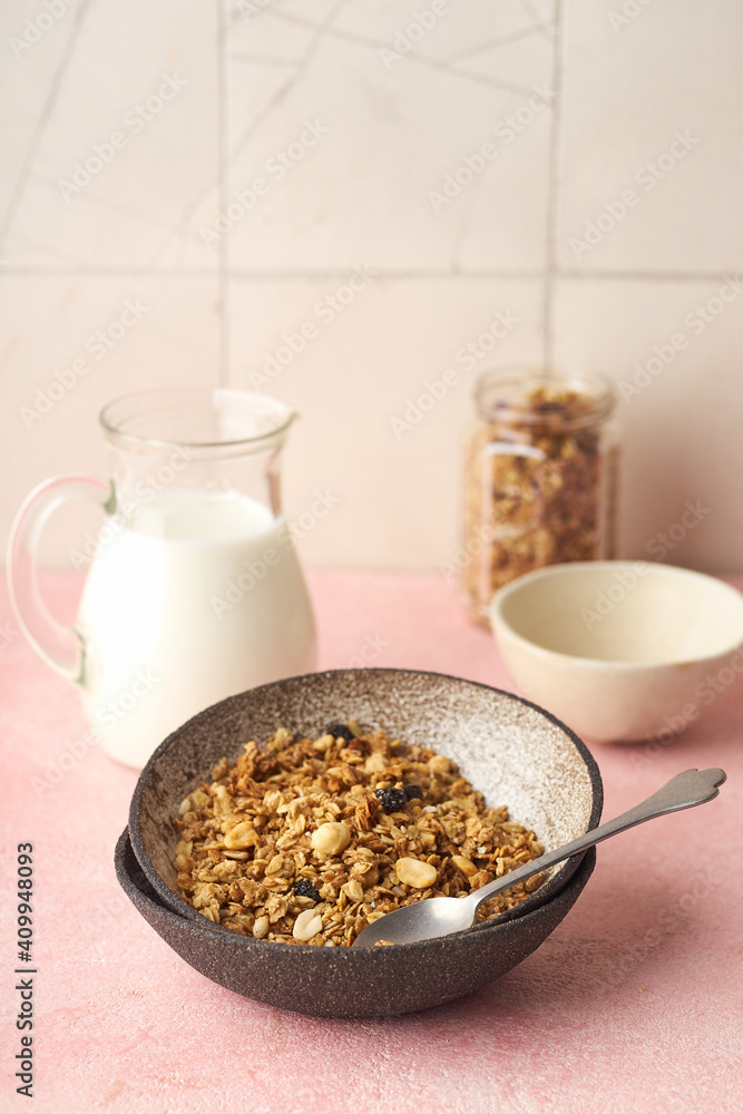 A bowl of granola with nuts, honey and oats served with milk A bowl of granola with nuts, honey and oats served with milk