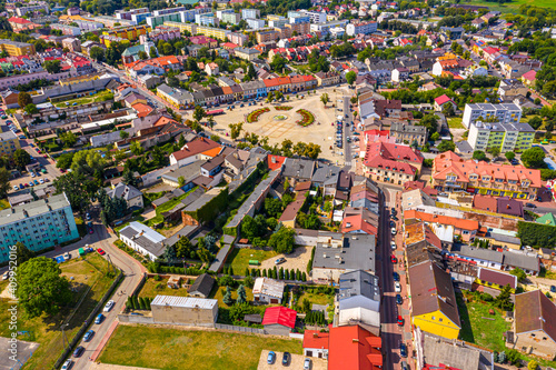 Top aerial panoramic view of Lowicz old town historical city centre with Rynek Market Square, Old Town Hall, New City Hall, colorful buildings with multicolored facade and tiled roofs, Poland © netsay