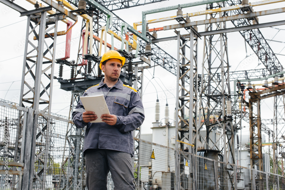 The energy engineer inspects the equipment of the substation. Power engineering. Industry