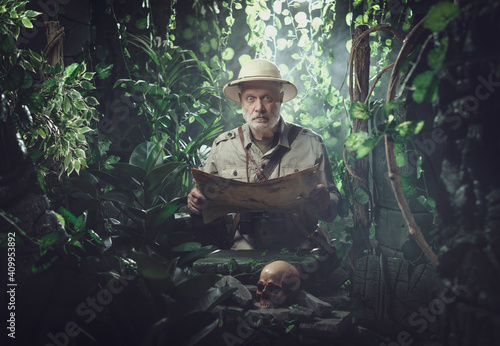 Fotografie Explorer checking a map in the forest