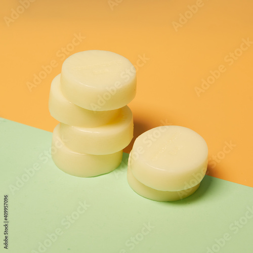 Natural round shaped soap arranged on two colored background in studio photo