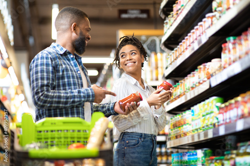 Happy African Family Couple Buying Food In Supermarket
