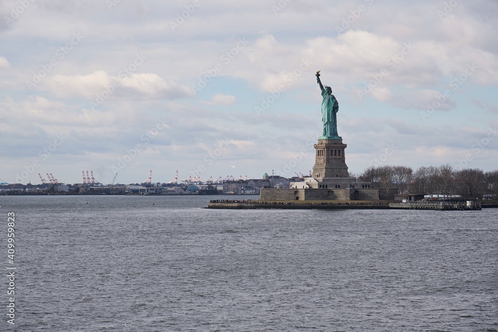 Distant view of famous national monument of Statue of Liberty in New York city Distant view of famous national monument of Statue of Liberty in New York city