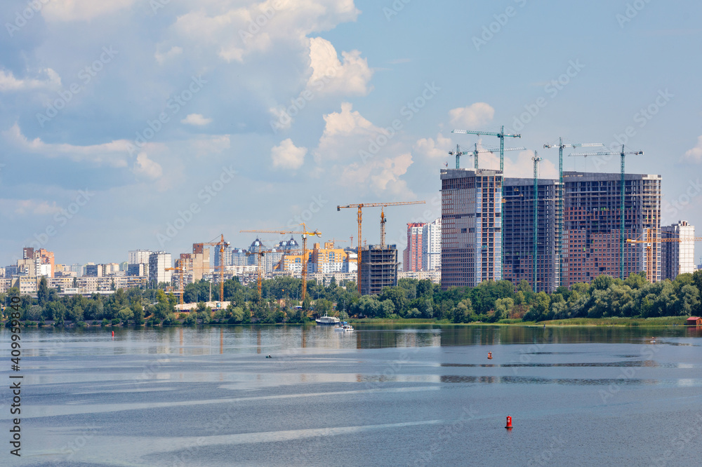 Cityscape, new residential buildings are being built on the banks of the Dniprо River.