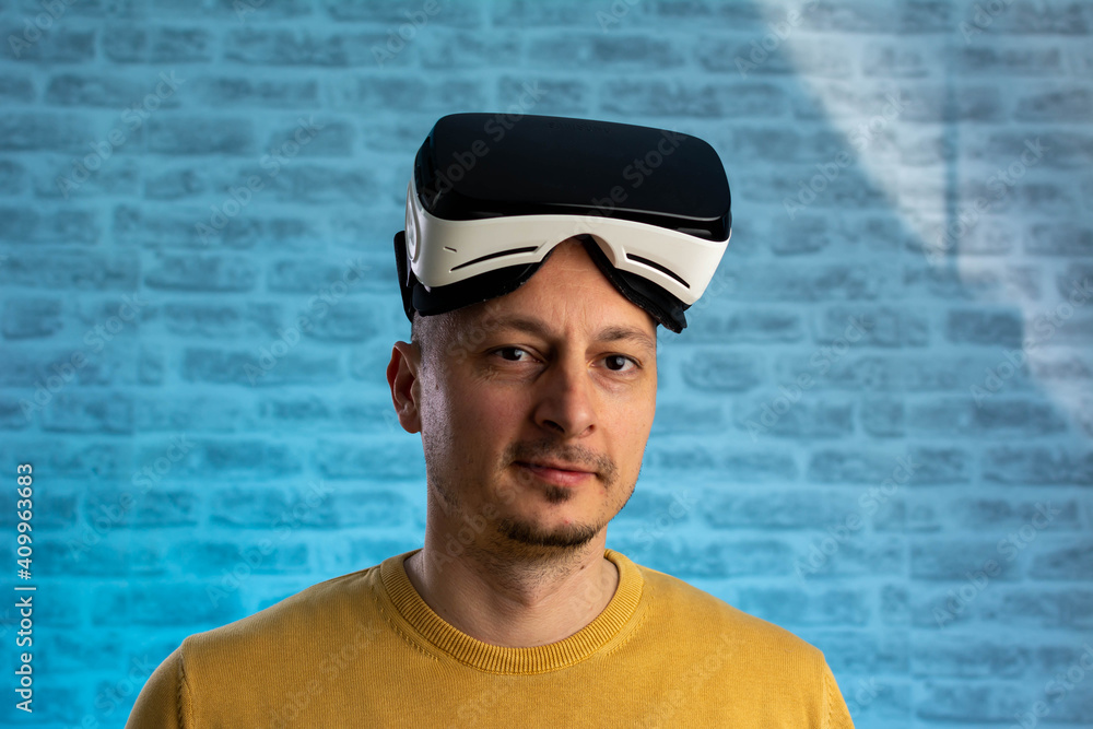 Portrait of a cheerful middle aged man with VR goggles in a studio, neon lights. People, technology, innovation and gaming concept. Portrait of happy man wearing vr goggles, experiencing vr Portrait of a cheerful middle aged man with VR goggles in a studio, neon lights. People, technology, innovation and gaming concept. Portrait of happy man wearing vr goggles, experiencing vr