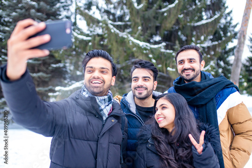 arabic guys having great time on Christmas holidays taking selfie photo on phone
