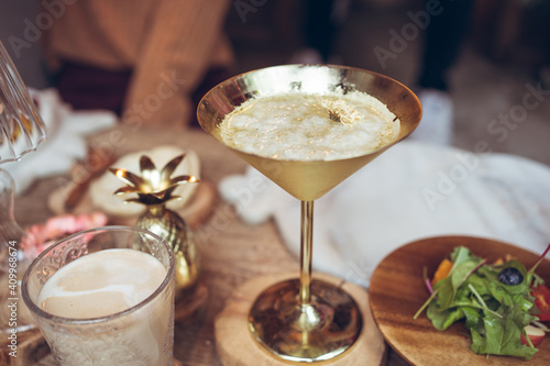 Wallpaper Mural High angle of metal cup with cold alcohol cocktail served on table with drinks and dishes during dinner in hotel of Taiwan Torontodigital.ca
