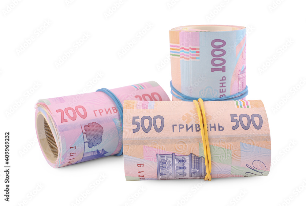 Rolls of Ukrainian money on white background