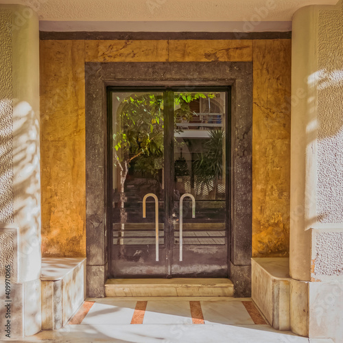 residential apartment building main entrance metal and glass door  Athens  Greece.