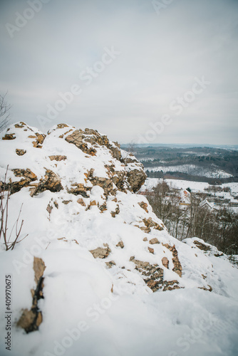 the rock with the view on Brdy, Crnolicke skaly, winter landscape covered by the cnow, cold cloudy day, woods and small village photo