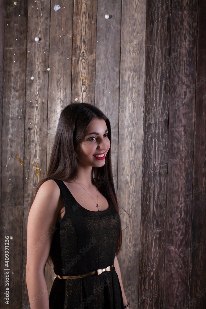 Obraz premium gorgeous arab girl portrait on wooden background. Sensual multicultural woman model. She is wearing gray sleeveless dress. Studio fashion shot