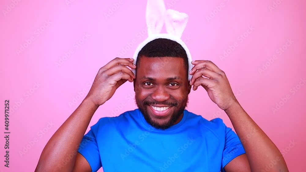 happy young brazil man with bunny ears in studio pink wall background happy young brazil man with bunny ears in studio pink wall background