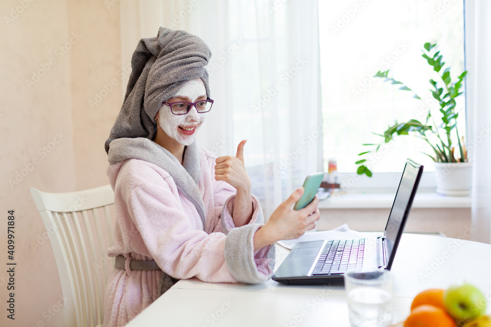 Woman applying facial clay mask. The young woman is working remotely. Concept of the workplace at home, working remotely. Creative. Woman applying facial clay mask. The young woman is working remotely. Concept of the workplace at home, working remotely. Creative.