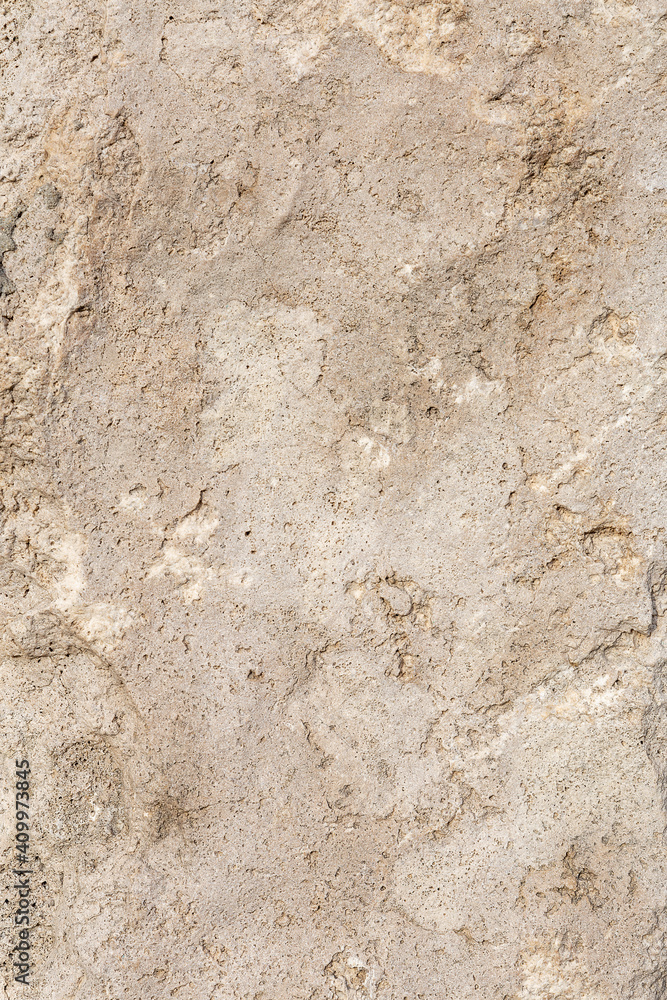 Empty, rough, uneven texture of a brown concrete wall close up with copy space