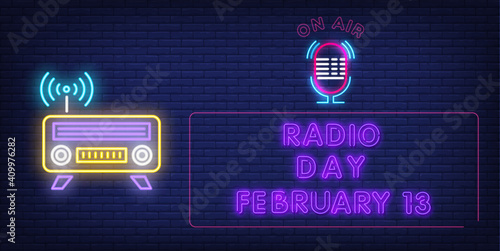 february 13 radio day poster in purple in rectangle with mic and radio set on navy blue brick background
