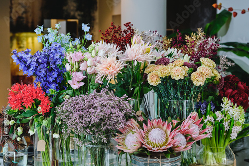 Wallpaper Mural Colorful assorted flowers and plants in baskets and vases placed in spacious floral shop Torontodigital.ca