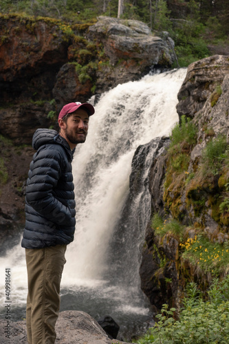 Hiker with Waterfall in Yellowstone National Park