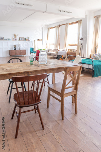 Wallpaper Mural Vintage studio apartment interior in light colors in old style. huge room with large windows with a living room area and a bedroom area. direct sunlight inside. Torontodigital.ca