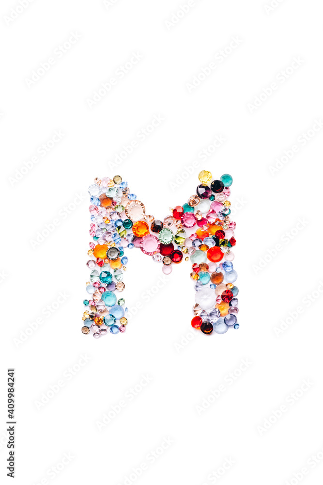Letter M made from beautiful glass bright gems or crystals on isolated white background Letter M made from beautiful glass bright gems or crystals on isolated white background
