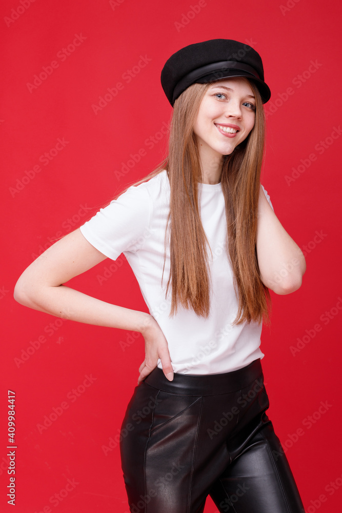 Attractive girl in stylish clothes and beret on a red background Attractive girl in stylish clothes and beret on a red background