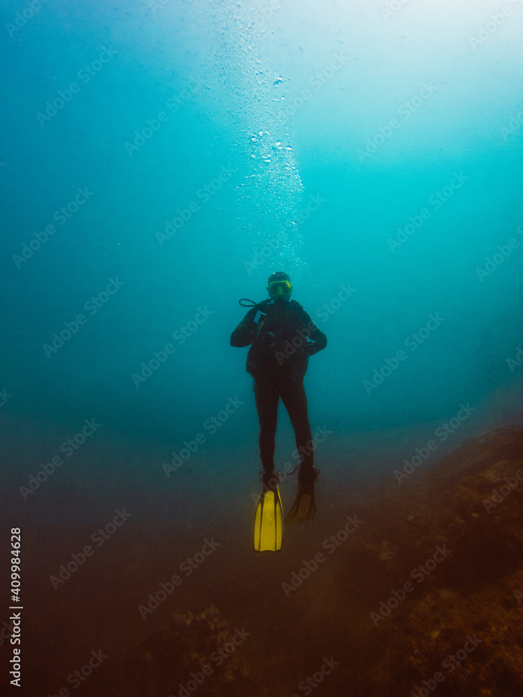 Unrecognizable diver studying depth of ocean and vegetation at bottom Unrecognizable diver studying depth of ocean and vegetation at bottom