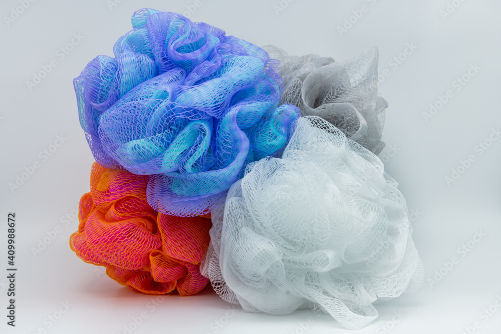 Four, bunch of beauty, hygiene loofah shower sponge to clean, cleanse body with bath puff orange, purple, blue, white and gray.  - obrazy, fototapety, plakaty 