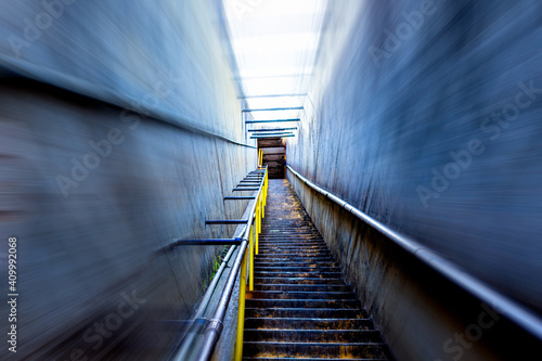 An eerie tunnel of stairs with motion blur ascending to an unknown exit.  © Endeavor Moore Media