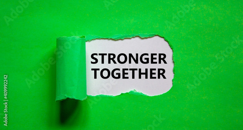 Stronger together symbol. Words Stronger together appearing behind torn green paper. Business, motivational and Stronger together concept. Copy space.