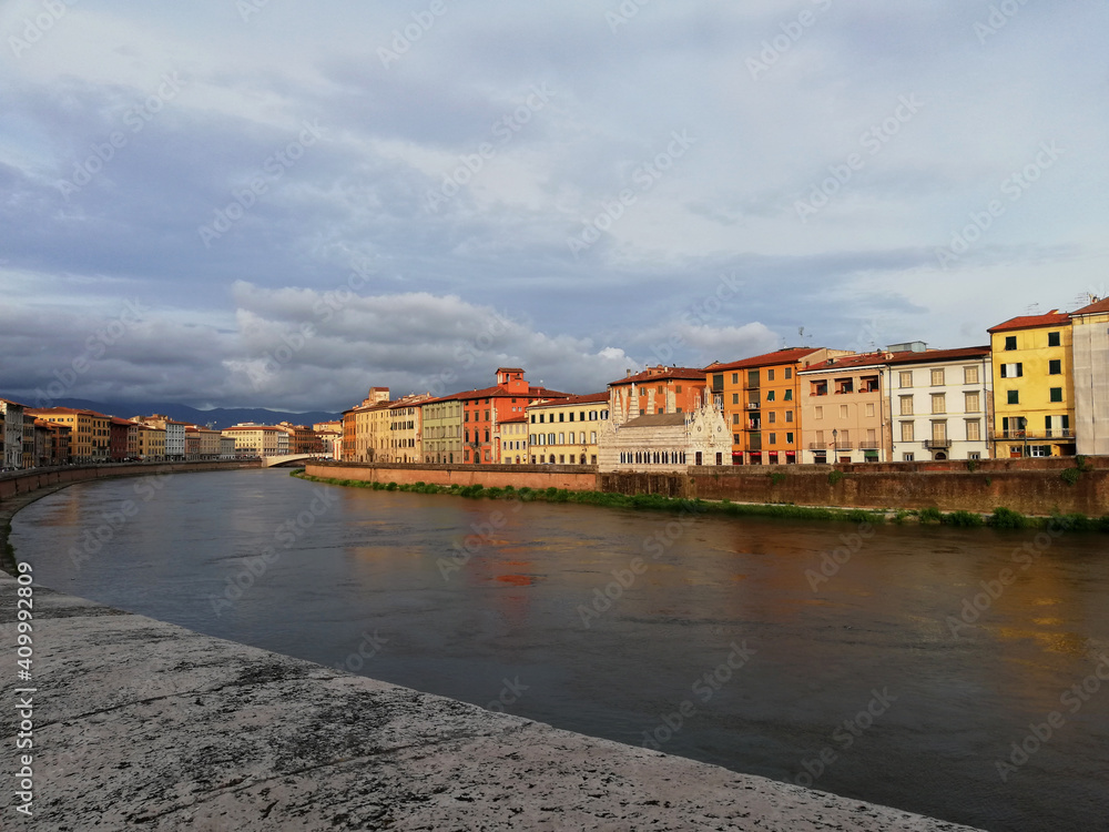 Pisa river and the beautiful colorful houses in Tuscany Italy
